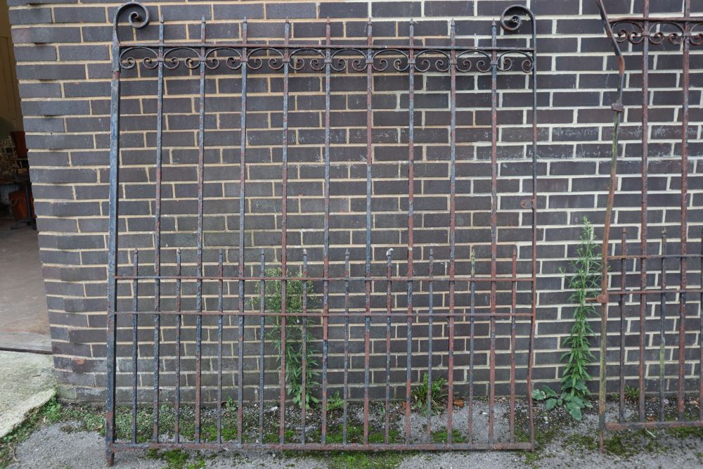 A pair of wrought iron gates, each gate 177cm wide, 193cm high